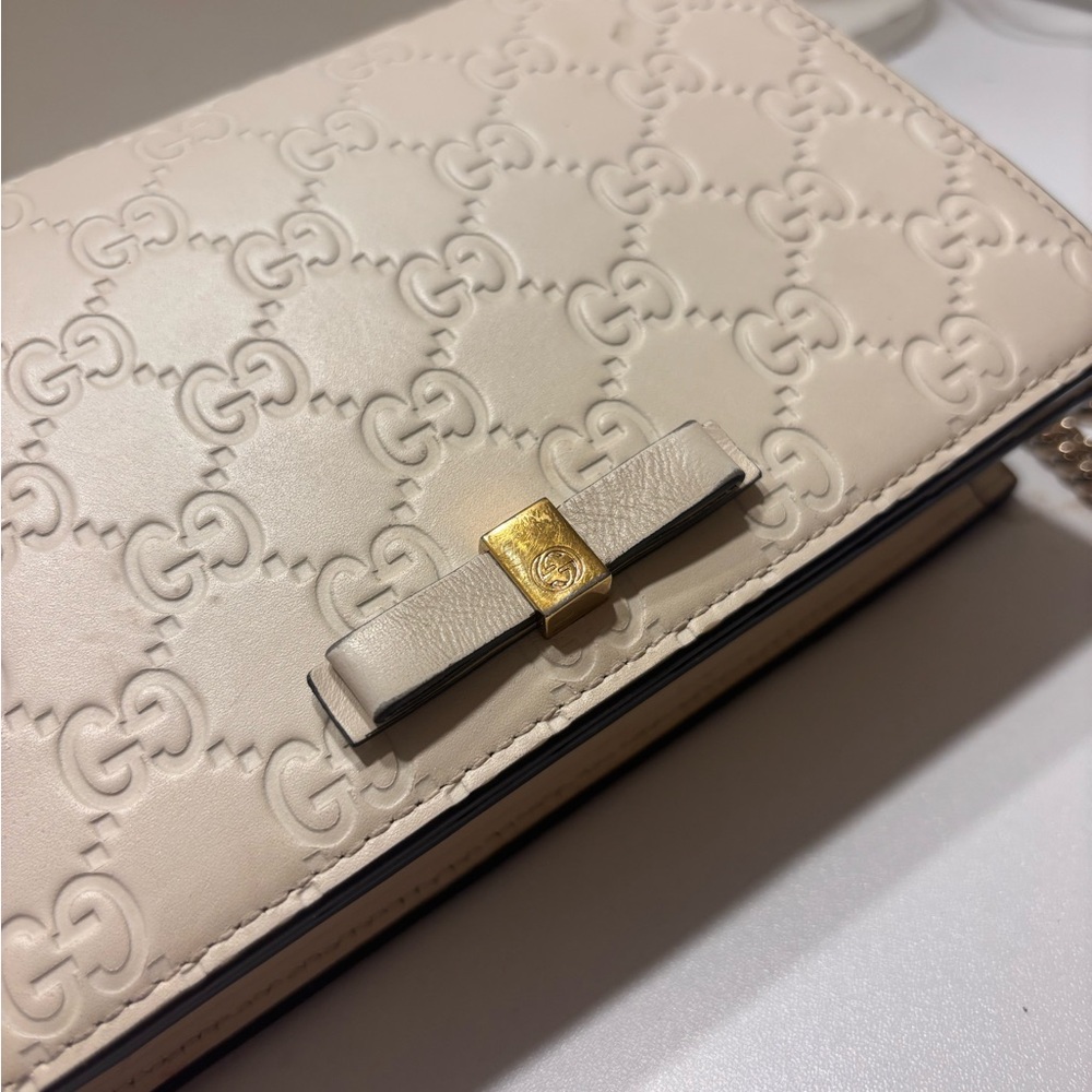 Gucci Beige Embossed Leather Clutch with Gold Bow